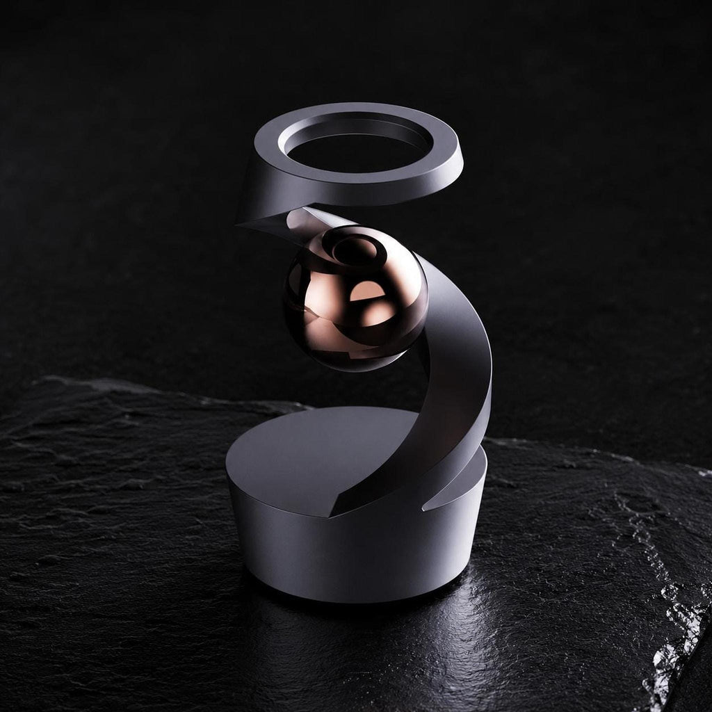 Gyroscope cinétique de bureau : structure spiralée noire et bille cuivrée